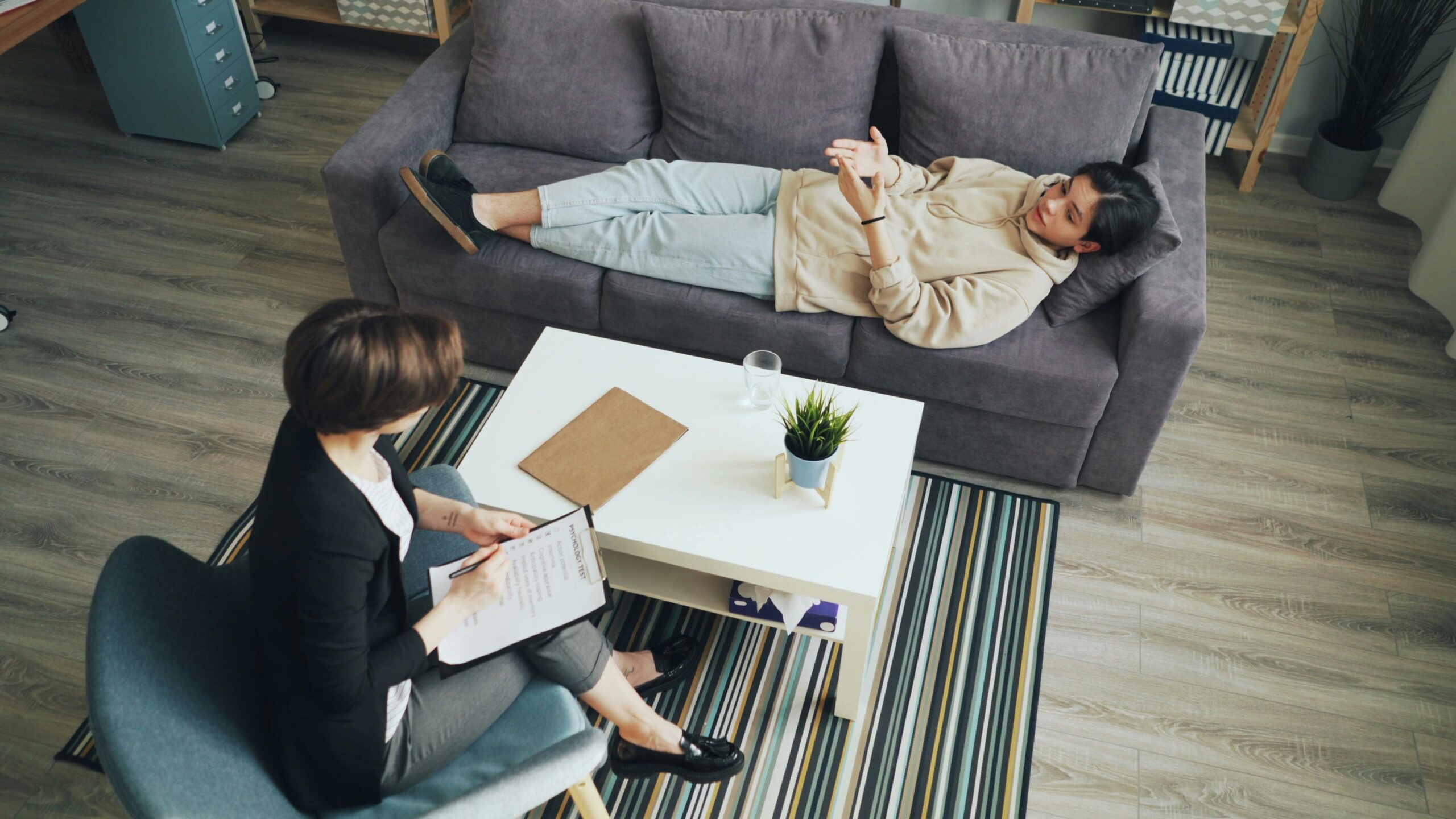 woman receiving therapeutic support services laying on a sofa